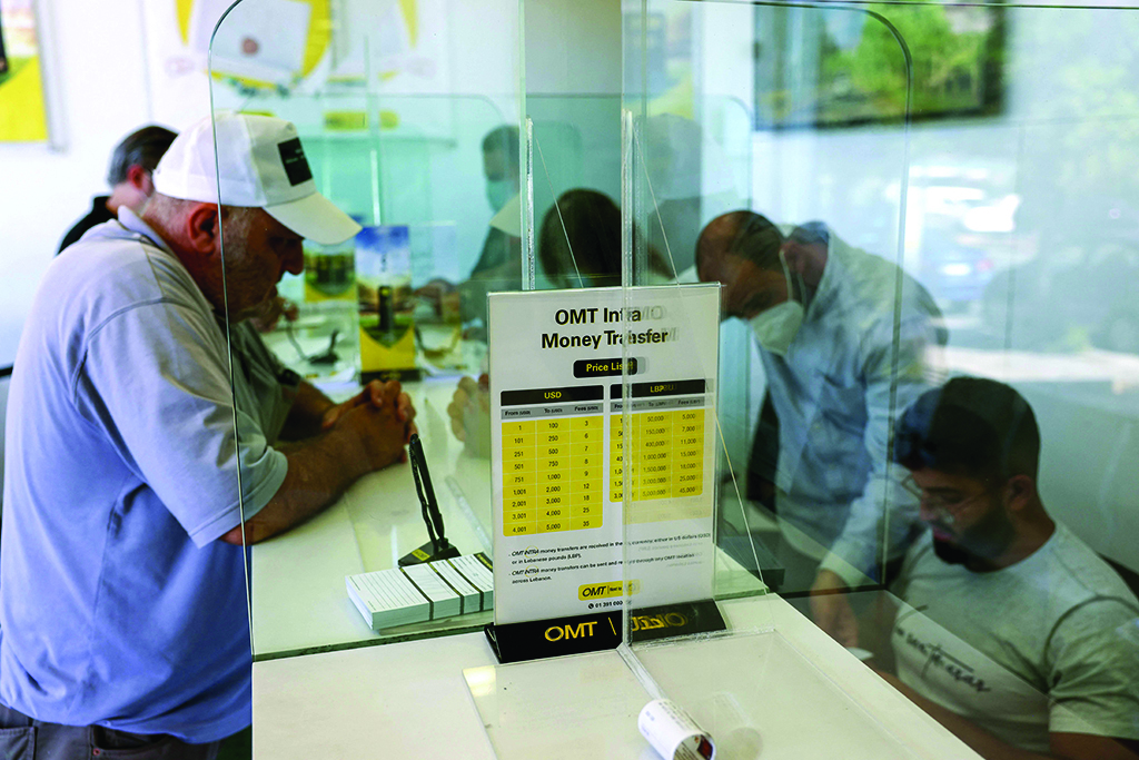 BEIRUT: Employees serve customers at a money transfer office on July 27, 2022. - AFP