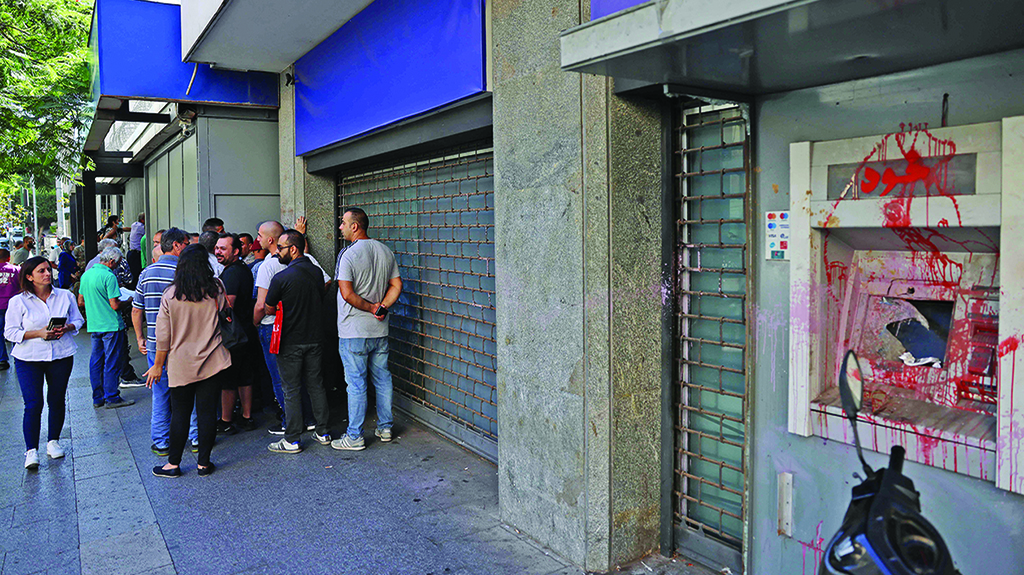 BEIRUT: Lebanese depositors queue to withdraw money from a Fransabank branch on Sept 26, 2022 as banks partially re-opened following a week of closure due to security concerns. - AFP