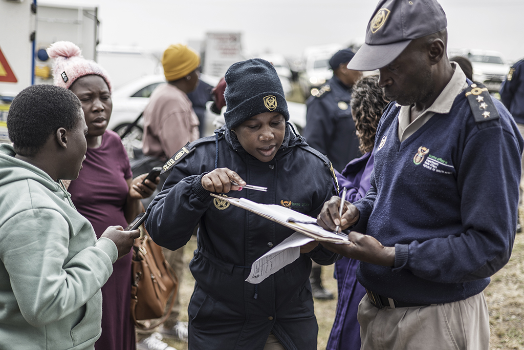 SPRINGS, South Africa: South African Home Affairs Immigration Officers check records of passport numbers of female migrant workers, during an operation run with the Home Affairs Immigration officers, in Springs on September 22, 2022. - AFP