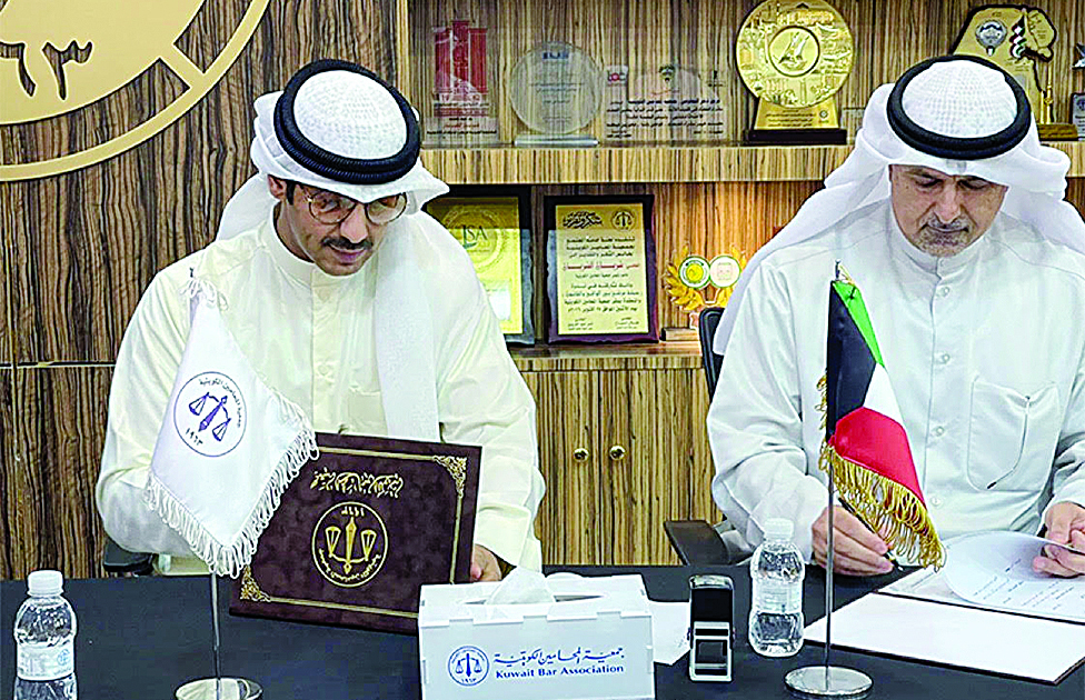 KUWAIT: KANF member Ahmad Al-Kandari and KLS member Abdulrazaq Al-Enezi sign the MoU.