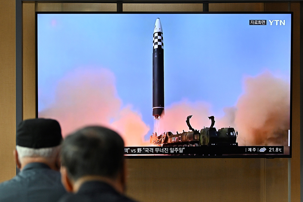 SEOUL, South Korea: People watch a television screen showing a news broadcast with file footage of a North Korean missile test, at a railway station in Seoul. – AFP