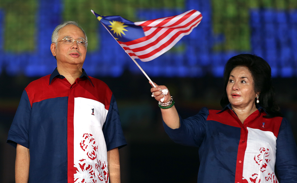 BUKIT JALIL: File photo shows Malaysia's then-Prime Minister Najib Razak (L) looks on as his wife Rosmah Mansor (R) waves a national flag during a rally to celebrate country's 55th Independence Day in Bukit Jalil Stadium. Rosmah Mansor was found guilty of graft on September 1, 2022.