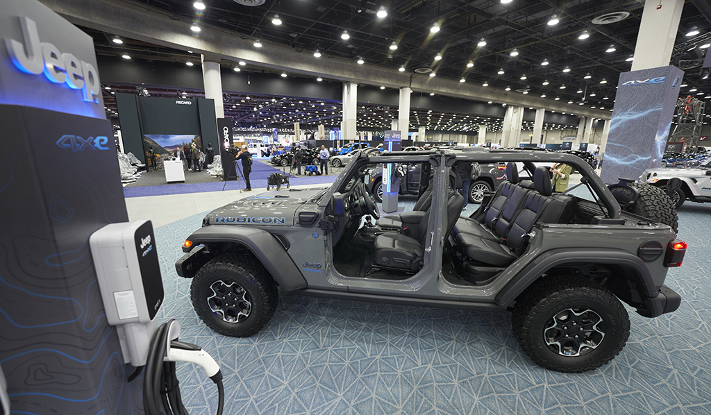 DETROIT: A charger stands next to a Jeep Wrangler 4xe at the 2022 North American International Auto Show in Detroit, Michigan on September 14, 2022. – AFP