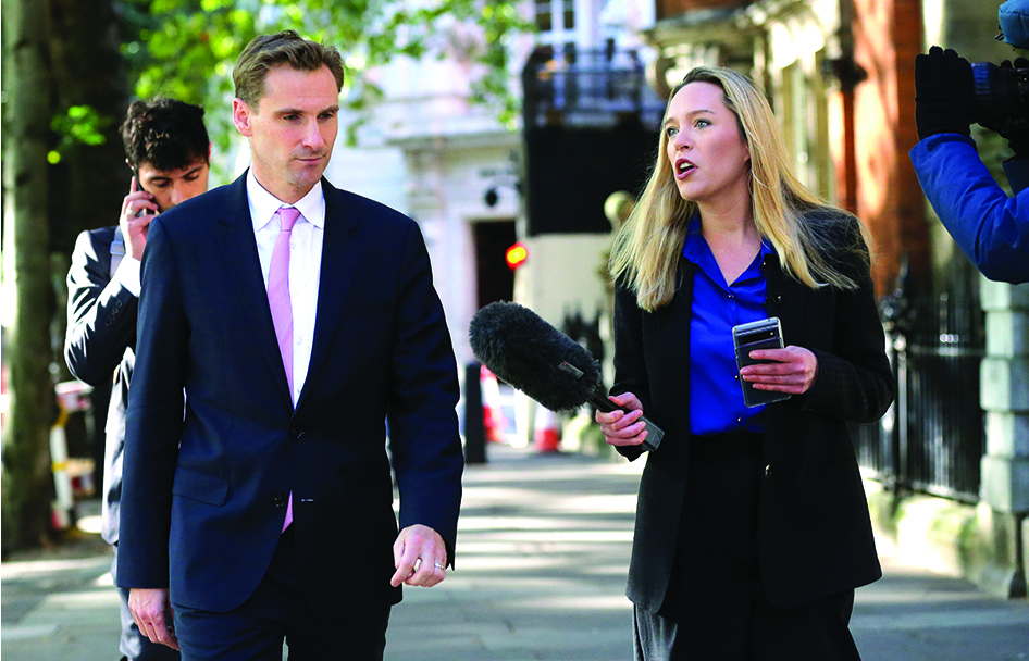 LONDON: Britain's Chief Secretary to the Treasury Chris Philp (left) is interviewed by a TV journalist as he leaves from Millbank Studios in central London on September 29, 2022. - AFP