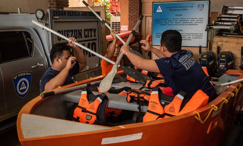 Members of the Disaster Risk Reduction and Management Office prepare rubber boats and life vests ahead of Super Typhoon Noru making landfall, at their headquarters in Quezon City, suburban Manila