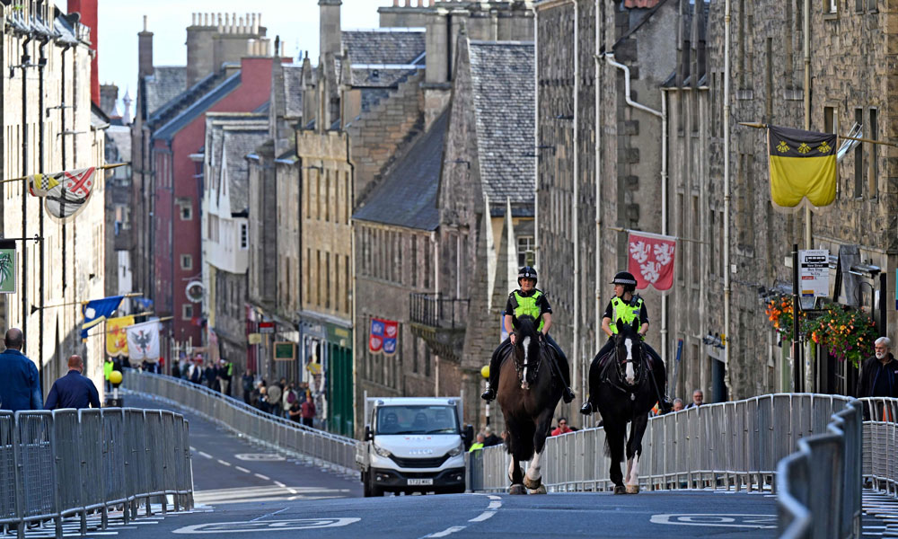 Mounted Police officers are seen on the Royal Mile in Edinburgh on September 10, 2022, as preparations continue for the arrival of Queen Elizabeth's coffin over the weekend