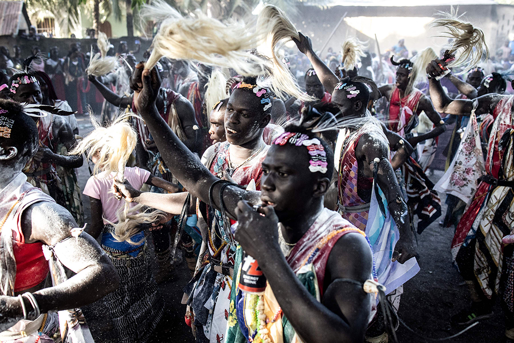Young men, who will start the initiation process the following year, blow whistles as they present themselves to the community, during a ceremony marking the end of the yearly initiation process for young men in Kabrousse, western Casamance.— AFP photos