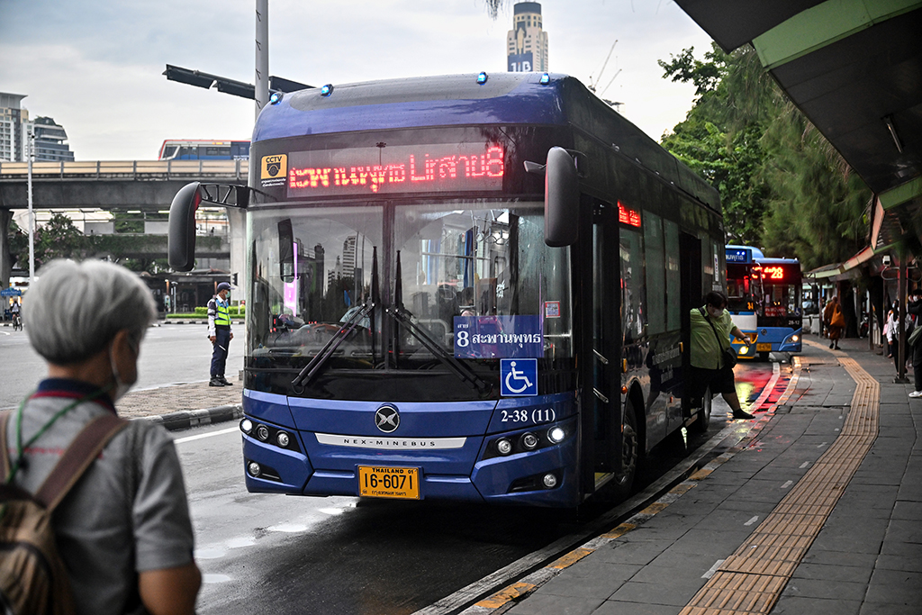 One of the new air-conditioned electric No.8 buses, complete with wheelchair access, at a bus stop in Bangkok.— AFP photos