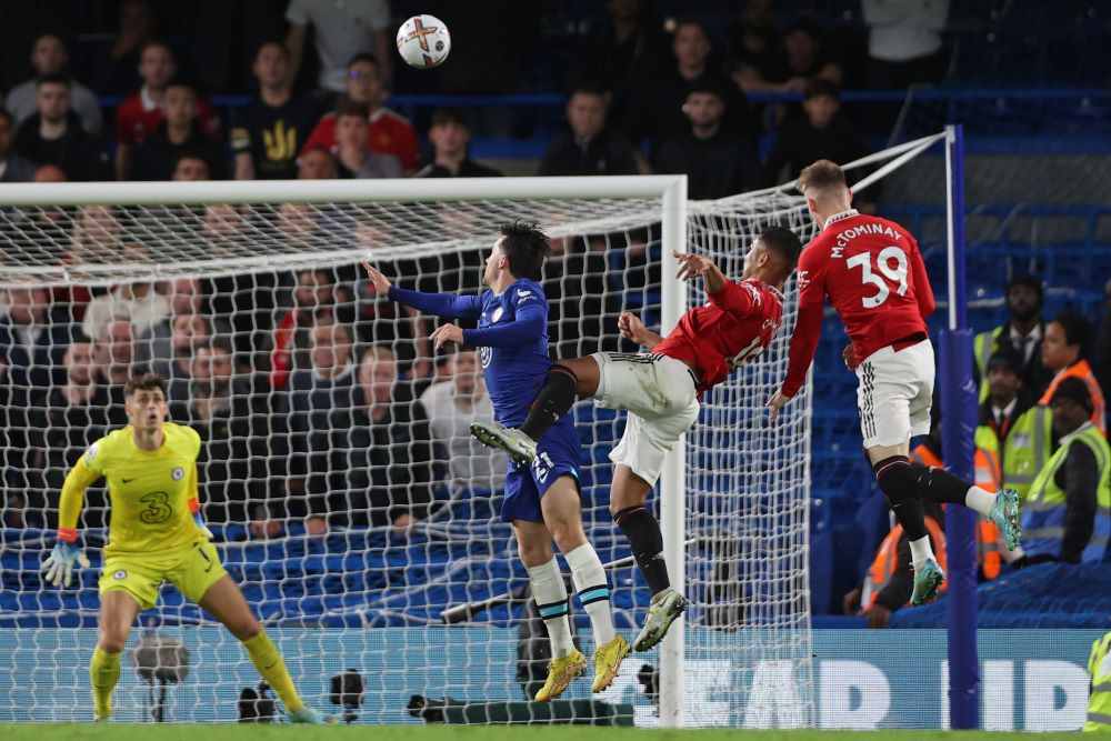 LONDON: Manchester United's Brazilian midfielder Casemiro (2nd R) jumps in a crowd of players to head home their late equalizing goal during the English Premier League football match between Chelsea and Manchester United at Stamford Bridge in London on October 22, 2022. - AFP