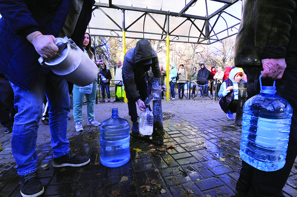 KYIV, Ukraine: Local residents wait in line to collect water from a public water pump in a park of Kyiv on October 31, 2022.- AFP