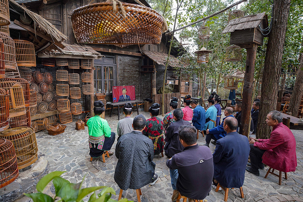 DANZHAI, China: Ethnic minority members watch the opening session of the 20th Chinese Communist Party Congress on a screen in Danzhai, in China’s southwestern Guizhou province on October 16, 2022. – AFP