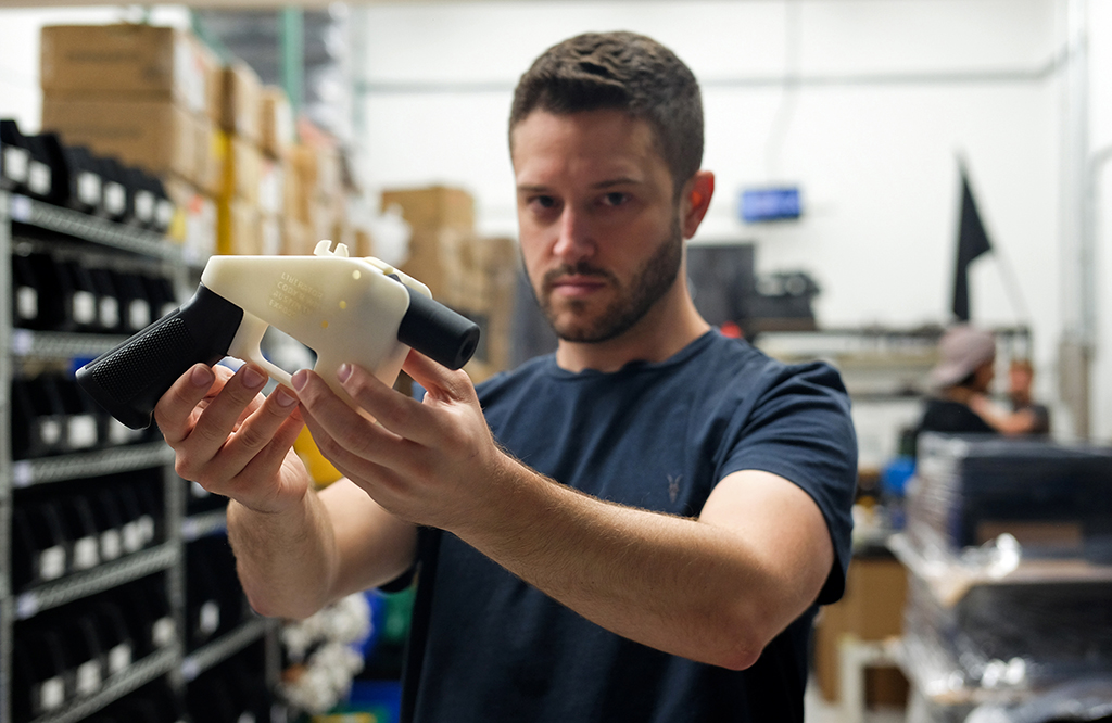 In this file photo, Cody Wilson, owner of Defense Distributed company, holds a 3D printed gun, called the ‘Liberator’, in his factory in Austin, Texas. – AFP photos