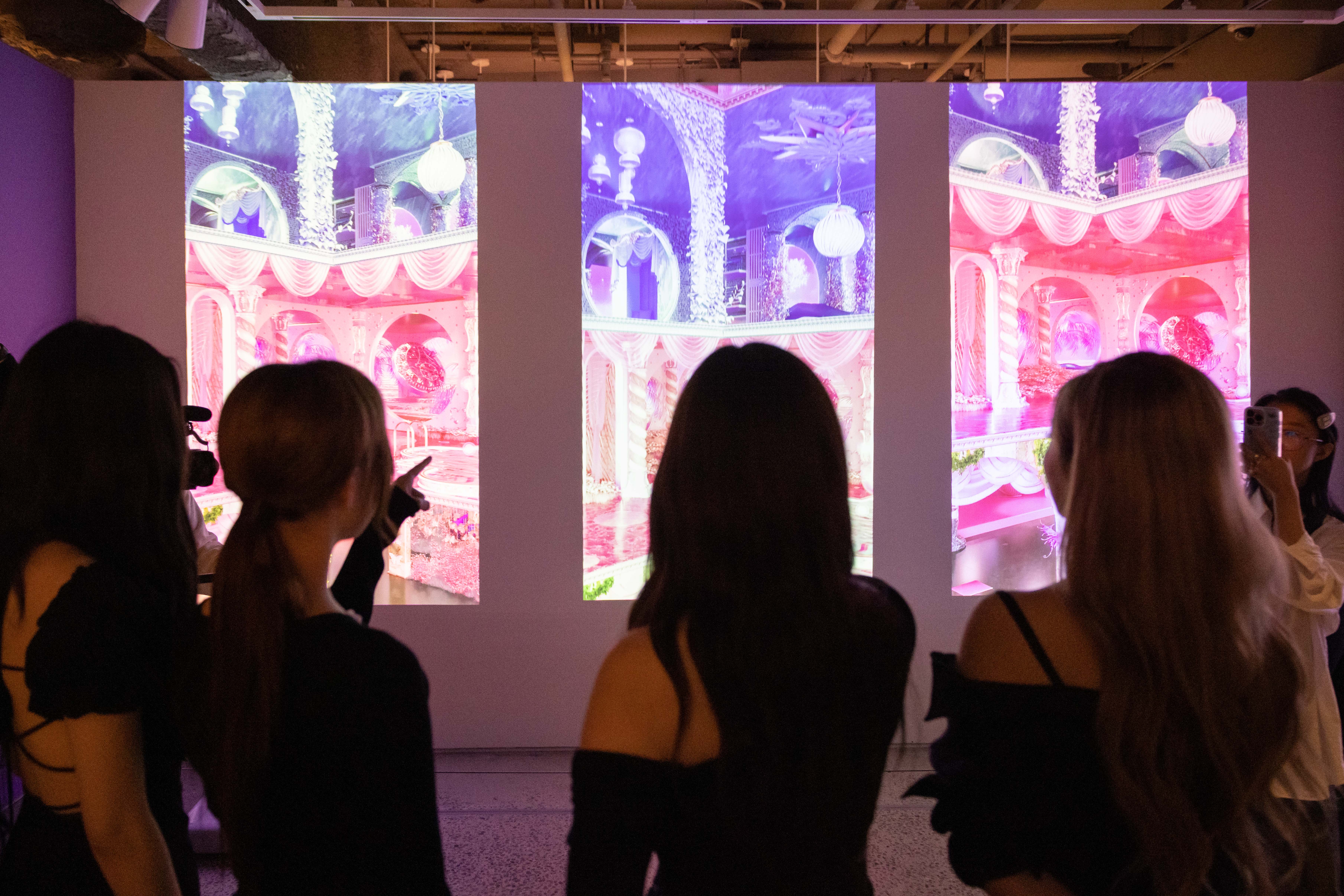 Members of female K-Pop group Aespa (from R) Ningning, Giselle, Winter and Karina look at their NFT artwork during the launch event for their NFT collection at Sotheby’s on October 14, 2022 in New York. – AFP n
