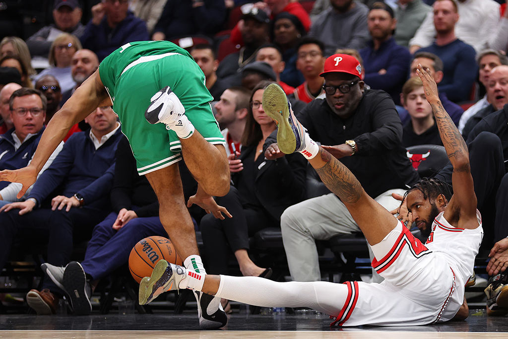 CHICAGO: Malcolm Brogdon #13 of the Boston Celtics and Derrick Jones Jr #5 of the Chicago Bulls collide during the second half at United Center on October 24, 2022 in Chicago, Illinois. - AFP