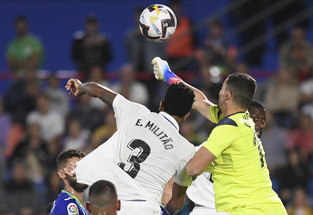 GETAFE: Real Madrid's Brazilian defender Eder Militao vies with Getafe's Spanish goalkeeper David Soria (right) during the Spanish League football match between Getafe CF and Real Madrid CF on October 8, 2022. - AFP