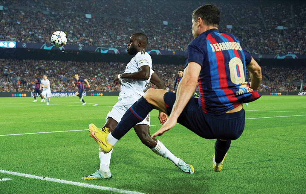 BARCELONA: Bayern Munich's French defender Dayot Upamecano (L) fights for the ball with Barcelona's Polish forward Robert Lewandowski during the UEFA Champions League 1st round day 5, Group C football match between FC Barcelona and FC Bayern Munich at the Camp Nou stadium in Barcelona. - AFP