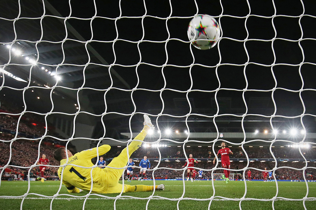 LIVERPOOL: Rangers' Scottish goalkeeper Allan McGregor (left) dives as Liverpool's Egyptian striker Mohamed Salah (center) shoots to score from the penalty spot during the UEFA Champions League group A football match on October 4, 2022. Liverpool won the game 2-0. - AFP