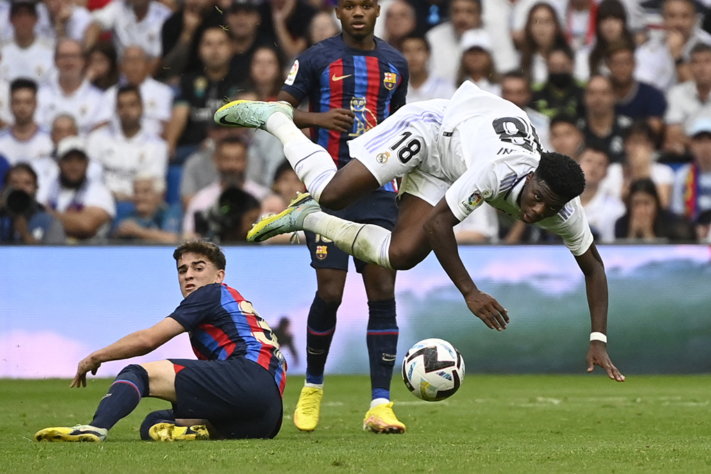 MADRID: Real Madrid's French defender Aurelien Tchouameni falls during the Spanish League football match between Real Madrid CF and FC Barcelona on October 16, 2022. - AFP