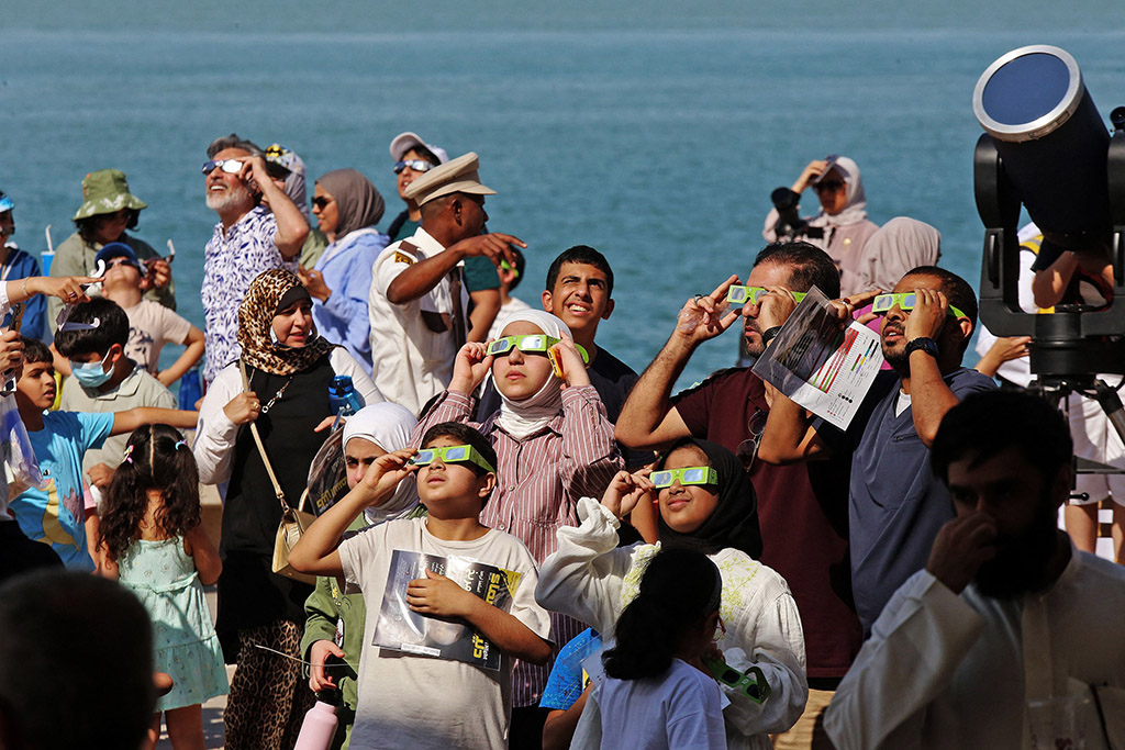 KUWAIT: People wearing protective glasses and equipment take a glimpse of a partial solar eclipse on Oct 25, 2022. - Photos by Yasser Al-Zayyat