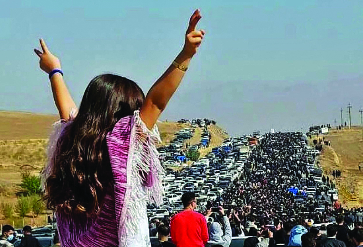 SAQEZ, Iran: Image posted on Twitter on Oct 26, 2022 shows an unveiled woman standing on top of a vehicle as thousands make their way towards Aichi cemetery in Mahsa Amini's hometown. - AFP n