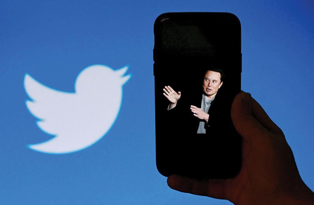 WASHINGTON: In this illustration photo taken on Oct 4, 2022, a phone screen displays a photo of Elon Musk with the Twitter logo in the background. - AFP