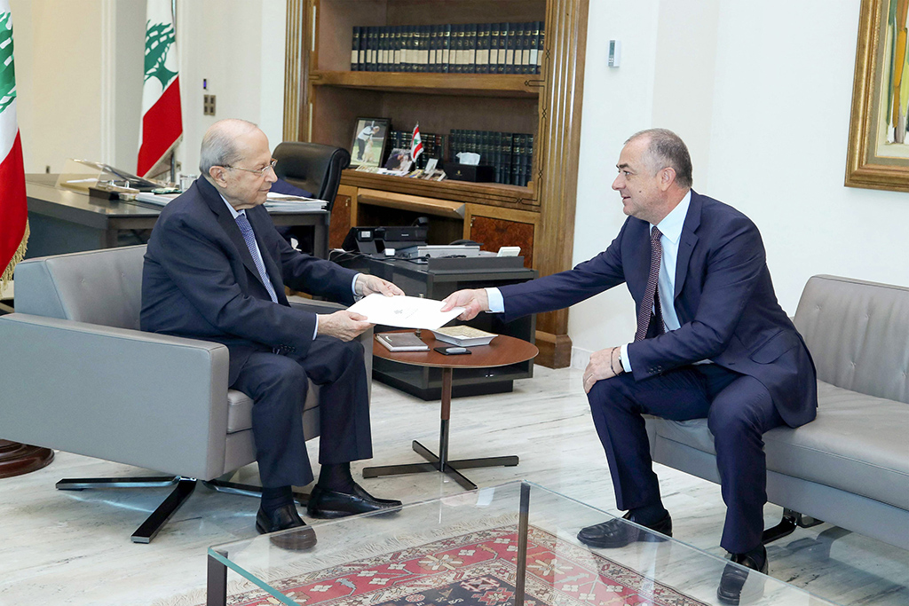 BAABDA, Lebanon: Lebanon's deputy parliament speaker and negotiator Elias Bou Saab hands the latest draft of a proposal to demarcate Lebanon's maritime border with the Zionist entity to Lebanese President Michel Aoun at the presidential palace on Oct 11, 2022. - AFP