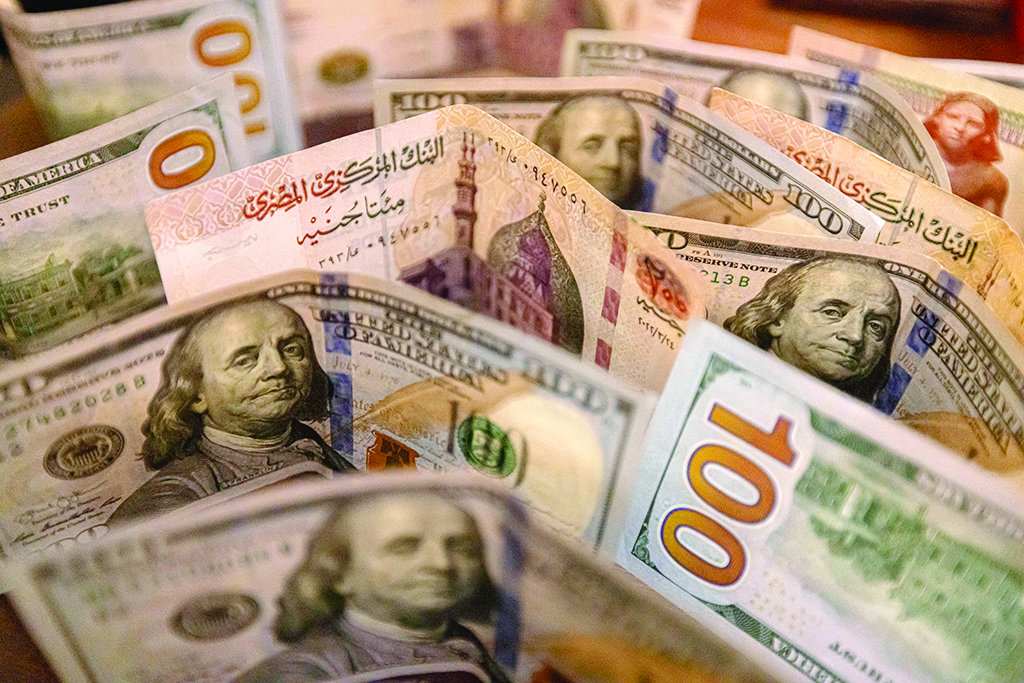 CAIRO: Photo shows Egyptian pound and US dollar banknotes. - AFP