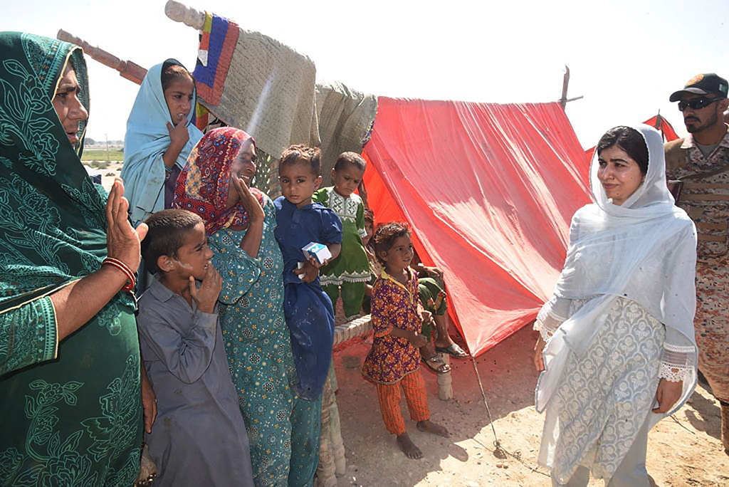 Nobel Peace laureate Malala Yousafzai meets flood-affected families at a makeshift camp in Johi in Dadu district of Sindh province on Oct 12, 2022. - AFP