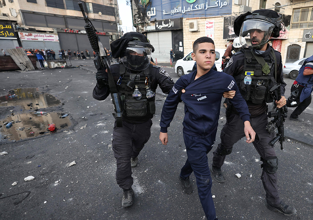 JERUSALEM: Members of the Zionist security forces arrest a young Palestinian protester during confrontations in the Shuafat refugee camp in Zionist-annexed east Jerusalem on Oct 12, 2022. - AFP