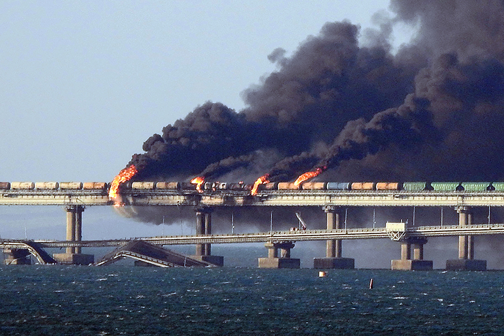 KERCH: Black smoke billows from a fire on the Kerch bridge that links Crimea to Russia, after a truck exploded, near Kerch, on October 8, 2022. – AFP