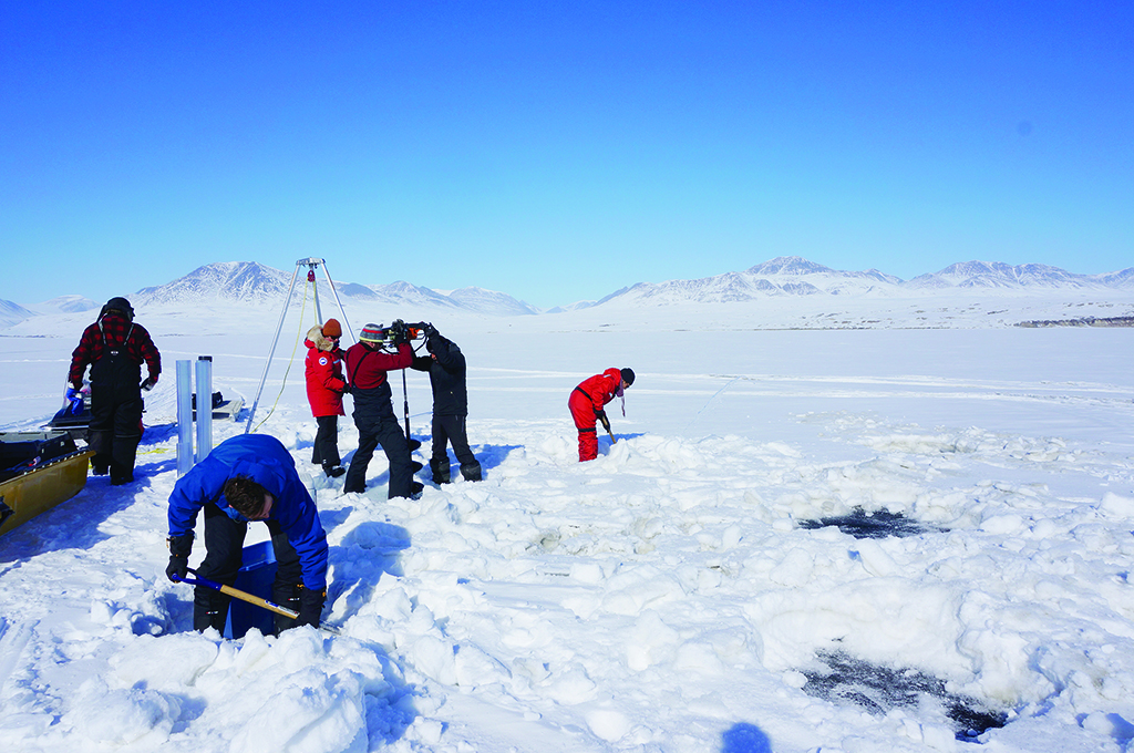 NUNAVUT: This handout picture shows researchers drilling holes to collect sediment at the Lake Hazen in Nunavut, to investigate how climate change might increase the risk of ‘viral spillover’. A warming climate could bring viruses in the Arctic into contact with new environments and hosts, increasing the risk of ‘viral spillover’, according to a research.- AFP