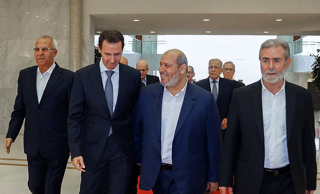 DAMASCUS, Syria: This handout picture released by the Syrian Presidency, shows Syria's President Bashar al-Assad (2-L) receiving the leader of Palestinian militant group Islamic Jihad, Ziad al-Nakhala (R) Hamas chief of Arab relations, Khalil al-Hayya (2-R) and secretary general of the Popular Front for the Liberation of Palestine, Talal Naji (L), in the capital Damascus. – AFP