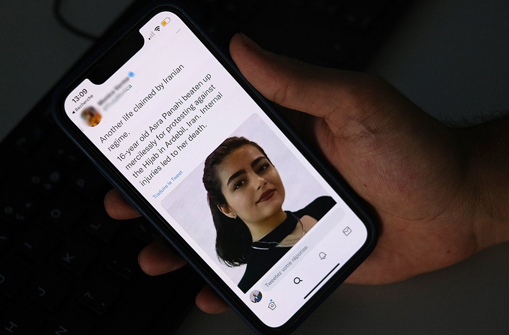 CAIRO: A person in Cairo looks on October 20, 2022 at a tweet about the reported death of 15-year-old Iranian girl Asra Panahi. The 15-year-old Iranian girl died last week after being beaten during a raid by the security forces on her school, a teachers' union said. –AFP