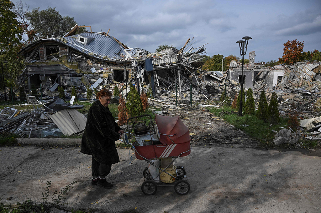 MYKOLAIVKA: A local resident walks past a destroyed building in Mykolaivka, eastern Ukraine amid the Russian invasion of Ukraine. - AFP