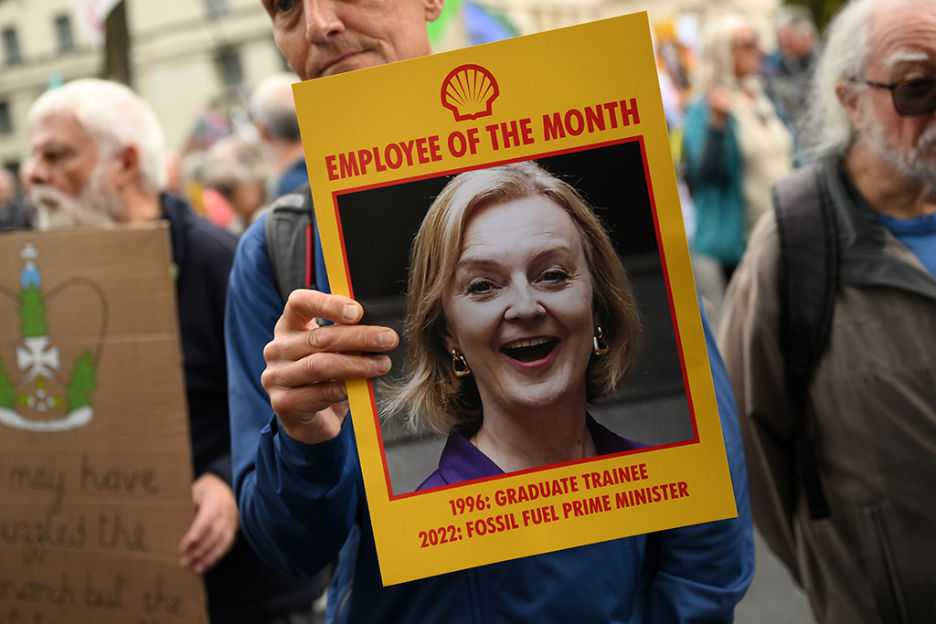 LONDON: A protester holds a placard showing Britain's Prime Minister Liz Truss, during a demonstration by the climate change protest group Extinction Rebellion, in central London.— AFP