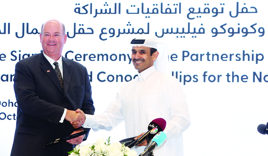 DOHA: Qatar's Minister of State for Energy Affairs and President and CEO of QatarEnergy Saad Sherida Al-Kaabi (right) and Ryan Lance, CEO of American multinational corporation ConocoPhillips, shake hands after signing an agreement at the QatarEnergy headquarters in Doha on October 30, 2022. – AFP