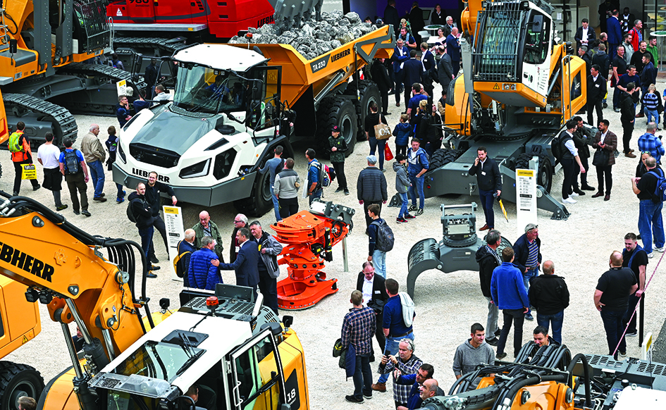 MUNICH: Visitors check out exhibits on the outdoor area of the 'Bauma 2022' Trade Fair for Construction Machinery, Building Material Machines, Mining Machines, Construction Vehicles and Construction Equipment in Munich, southern Germany.- AFP n