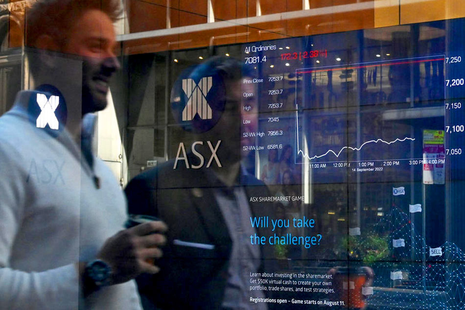 SYDNEY: Indicator boards are seen as people are reflected in the window of the Australian Securities Exchange (ASX) in Sydney, Australia. – AFP