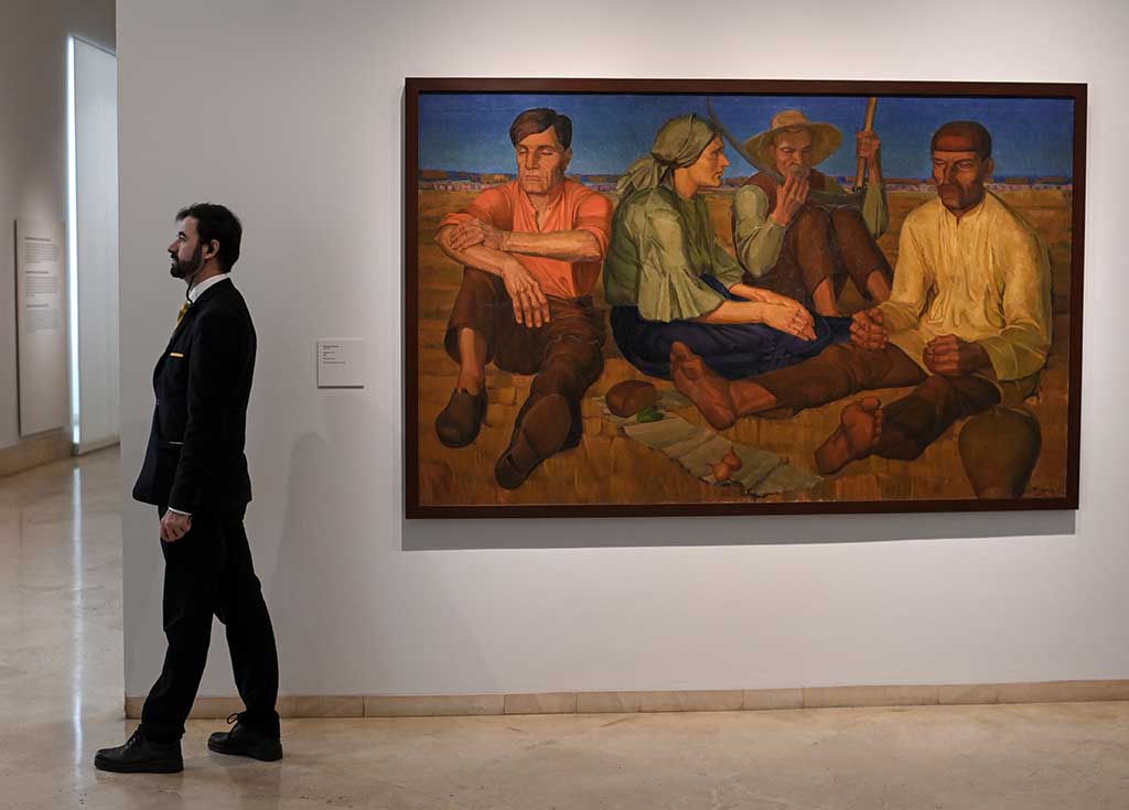 A gallery assistant stands near 'Rest' by Oleksandr Syrotenko during the press preview of 'In the Eye of the Storm' an exhibition on Ukrainian avant-garde art in the first decades of the 20th century at the Thyssen-Bornemisza museum.- AFP photos