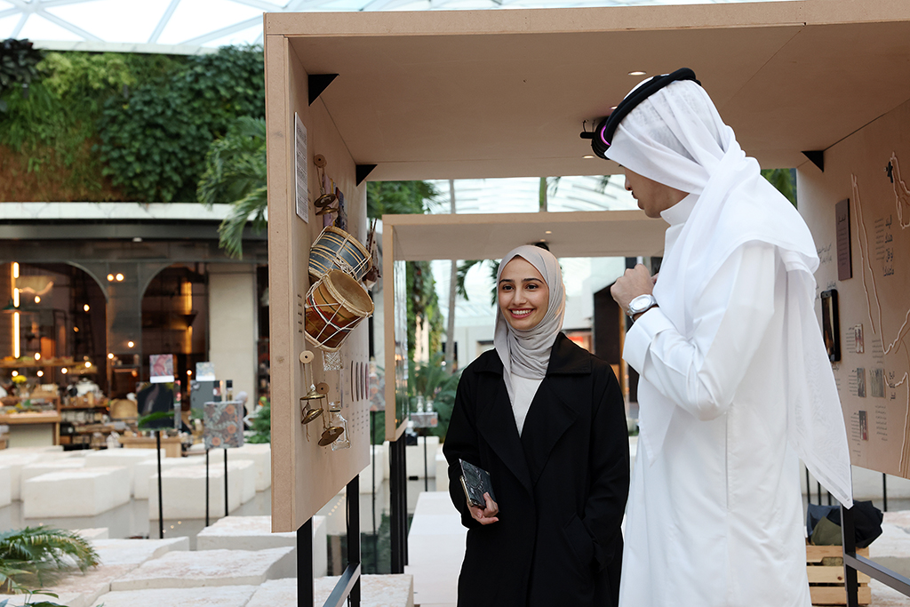Visitors checking out artworks on display at Rehla Exhibition.