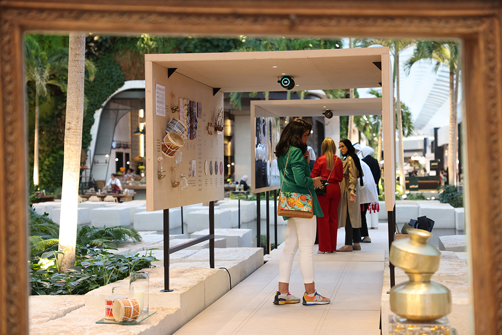 Visitors checking out artworks on display at Rehla Exhibition.