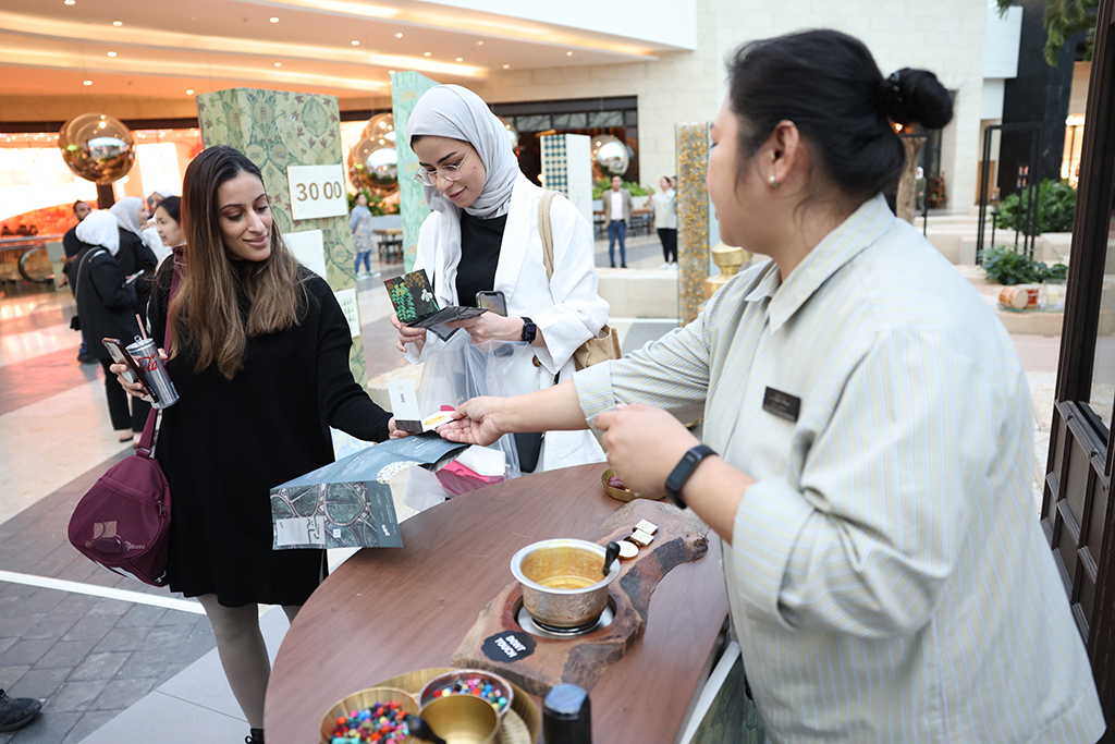 Visitors checking out artworks on display at Rehla Exhibition.