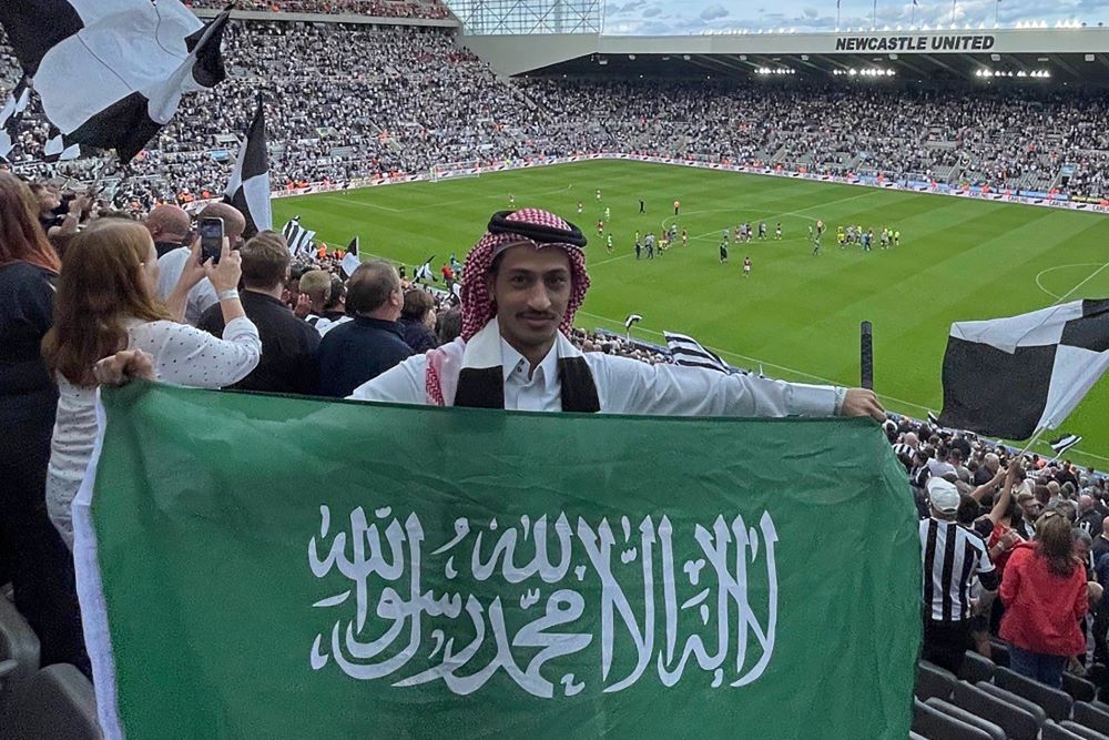 NEWCASTLE: Saudi Abdul Rahman Al-Qahtani carries the Saudi national flag during the English Premier League football match between Newcastle United and Nottingham Forest at St James' Park in Newcastle-upon-Tyne, on August 6, 2022. - AFP