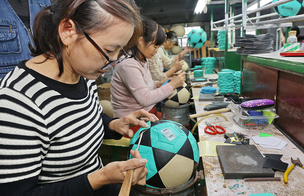NANTONG, China: Workers produce footballs at a factory in Nantong in China's eastern Jiangsu province on November 29, 2022. -  AFP