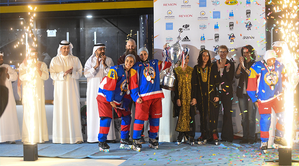 Kuwait women's team holding the cup.