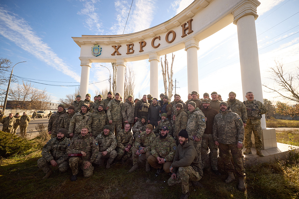 KHERSON, Ukraine:  This handout photograph shows Ukrainian President Volodymyr Zelensky (C) posing for a group photo with Ukrainian servicemen during his visit to the newly liberated city of Kherson, following the retreat of Russian forces from the strategic hub. - AFP