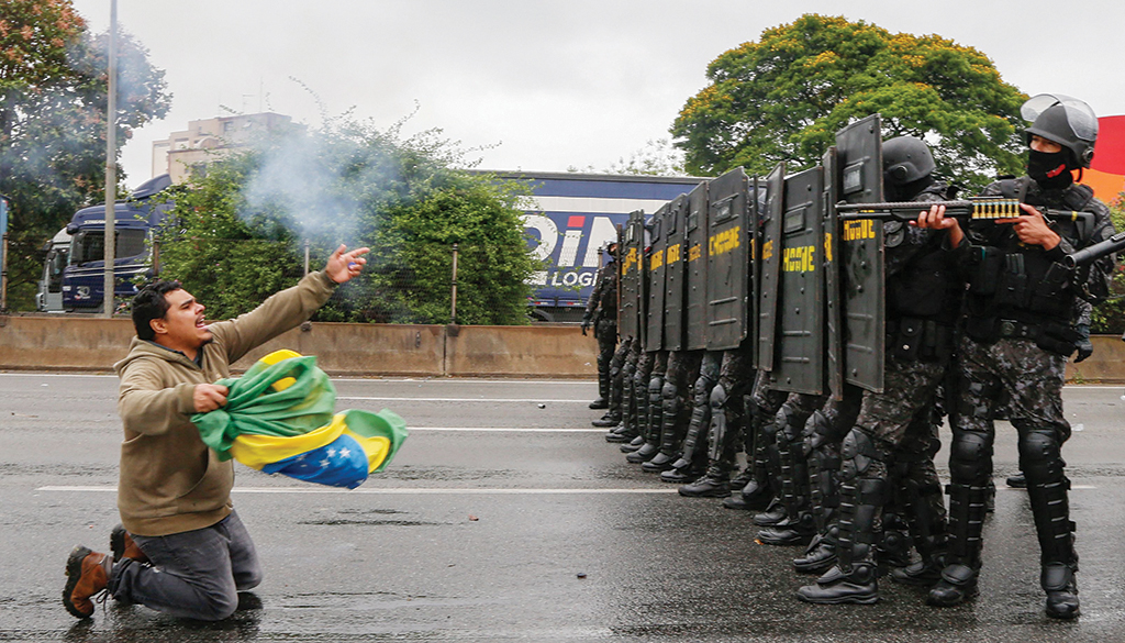SAO PAULO: Riot police take position to clear a blockade held by supporters of President Jair Bolsonaro on the Castelo Branco highway, on the outskirts of Sao Paulo, Brazil. - AFP