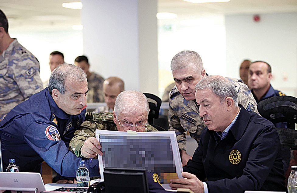 ANKARA, Turkey: Ministry of National Defence of Turkey on November 20, 2022, Turkey's Defence Minister Hulusi Akar (R) chairs a new air operation in northern regions of Iraq and Syria with members of the Turkish Armed Forces (TSK) command level at the Turkish Air Force Operations Centre in Ankara. - AFP