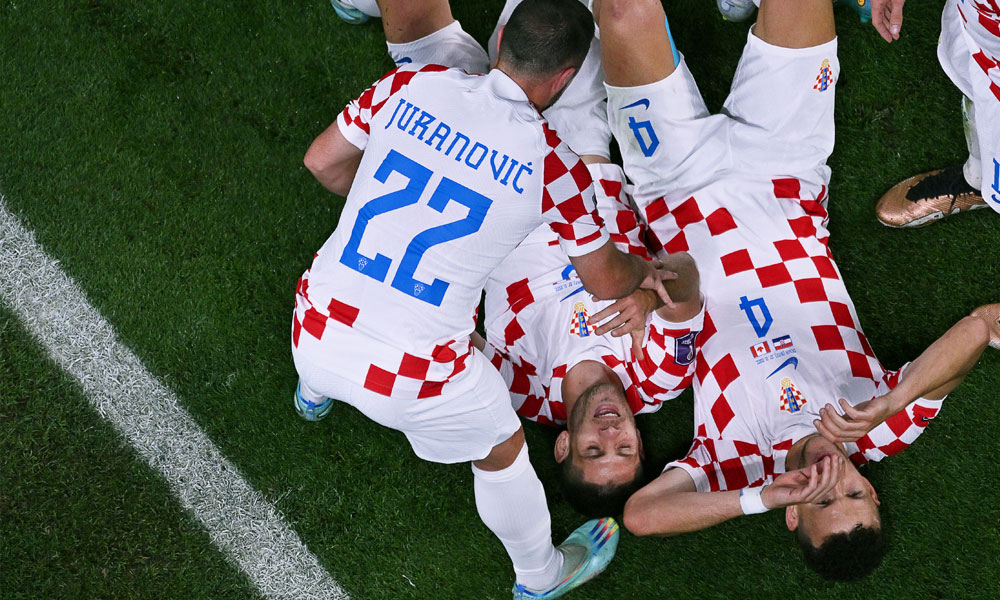 Croatia's forward #09 Andrej Kramaric (C) celebrates with teammates after scoring his team's third goal during the Qatar 2022 World Cup
