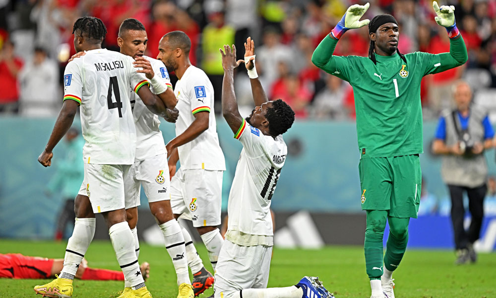 Ghana's players including Ghana's goalkeeper #01 Lawrence Ati Zigi (R) react after the Qatar 2022 World Cup Group H football match between South Korea and Ghana at the Education City Stadium in Al-Rayyan
